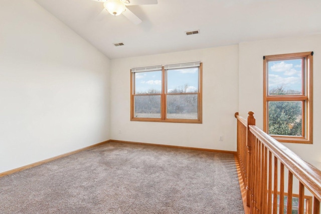 unfurnished room with carpet flooring and vaulted ceiling