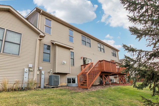 back of property with cooling unit, a deck, and a lawn