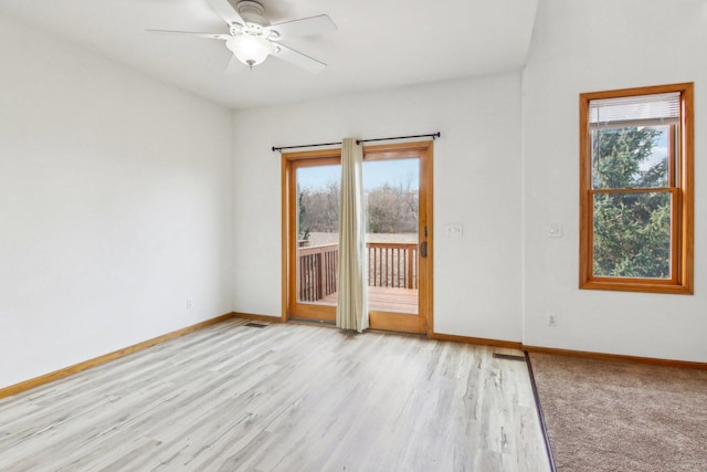 spare room with light wood-type flooring and ceiling fan