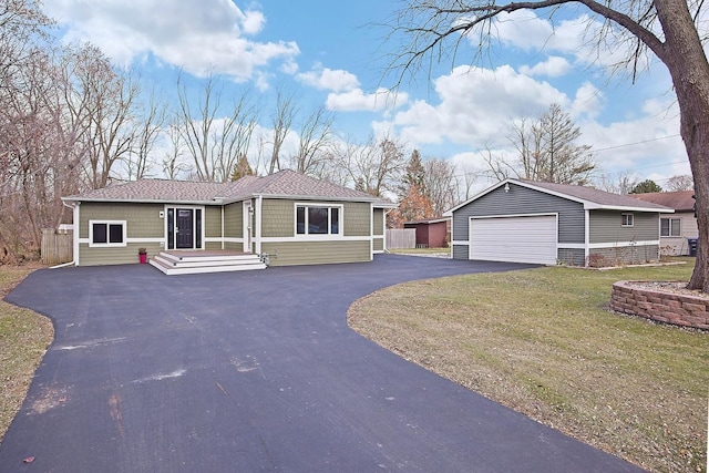 view of front of property featuring a garage, an outbuilding, and a front yard