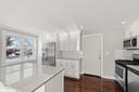 kitchen featuring white cabinets and white electric stove