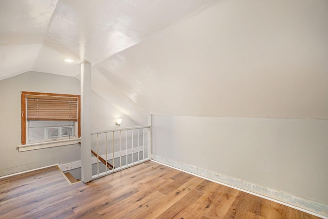 bonus room featuring wood-type flooring and vaulted ceiling