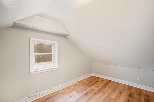 bonus room with lofted ceiling and light hardwood / wood-style flooring