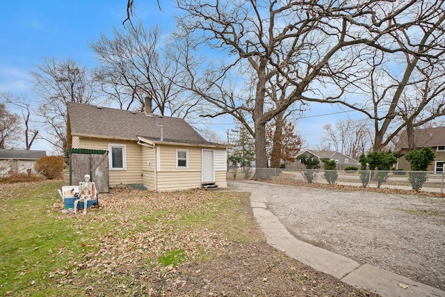 view of side of property with a yard