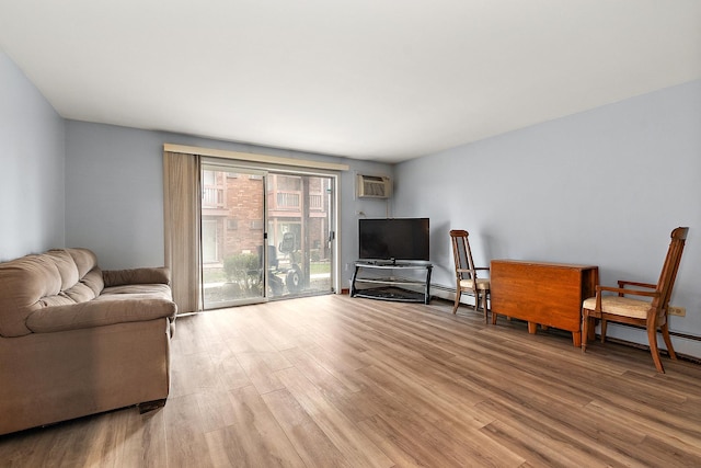 living room with light hardwood / wood-style floors and a wall mounted AC