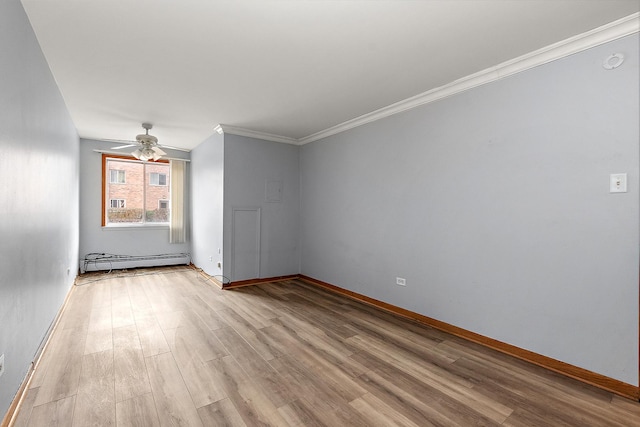 spare room with crown molding, ceiling fan, a baseboard heating unit, and light wood-type flooring