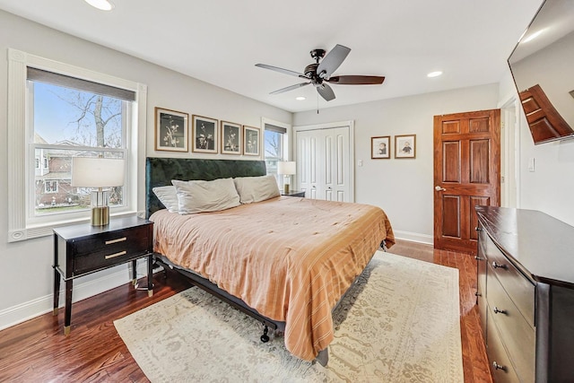 bedroom with ceiling fan, dark hardwood / wood-style floors, and a closet