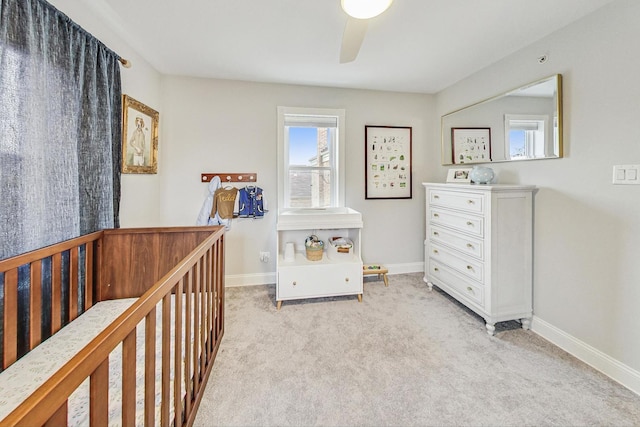 bedroom featuring light colored carpet and ceiling fan