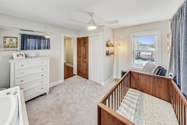 carpeted bedroom with a closet and ceiling fan