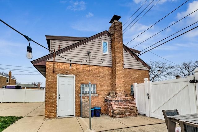 rear view of property featuring a patio