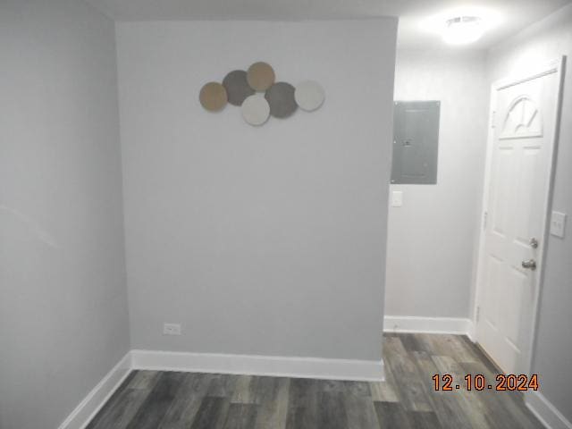 unfurnished room featuring dark wood-type flooring and electric panel