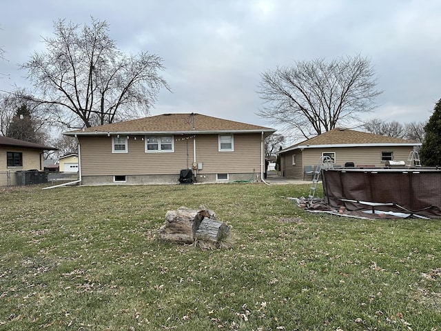 back of house with a lawn