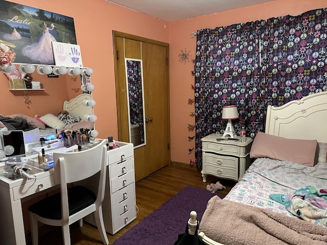 bedroom with wood-type flooring and a closet