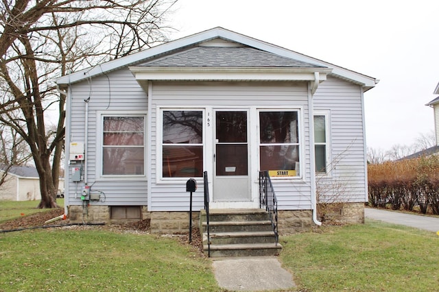 bungalow-style home featuring a front yard