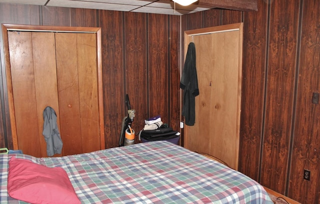 bedroom with wood walls