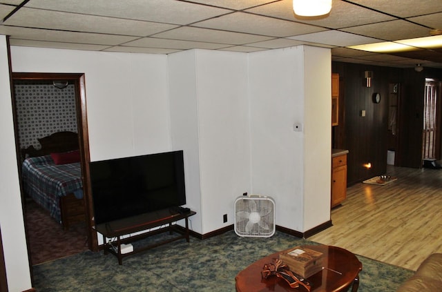 living room featuring hardwood / wood-style flooring and a paneled ceiling