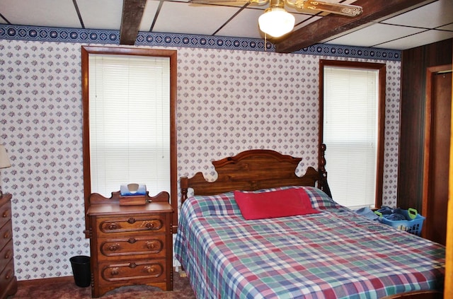 bedroom featuring beamed ceiling and ceiling fan