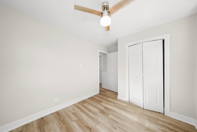 unfurnished bedroom featuring ceiling fan, a closet, and light hardwood / wood-style floors