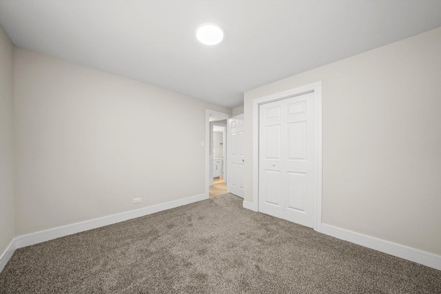 unfurnished bedroom with carpet and a closet