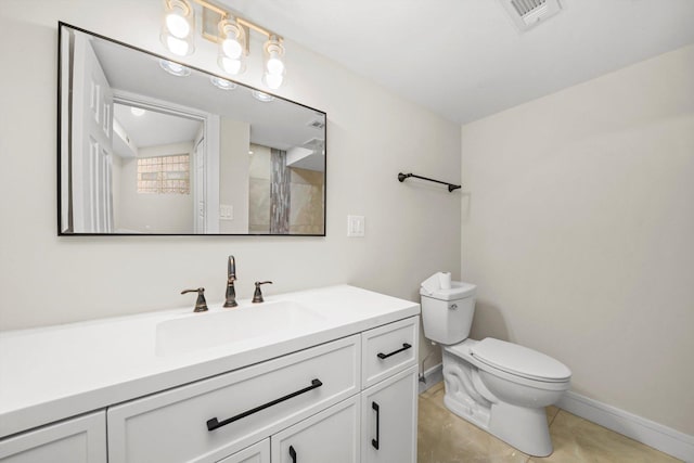 bathroom featuring tile patterned floors, vanity, and toilet