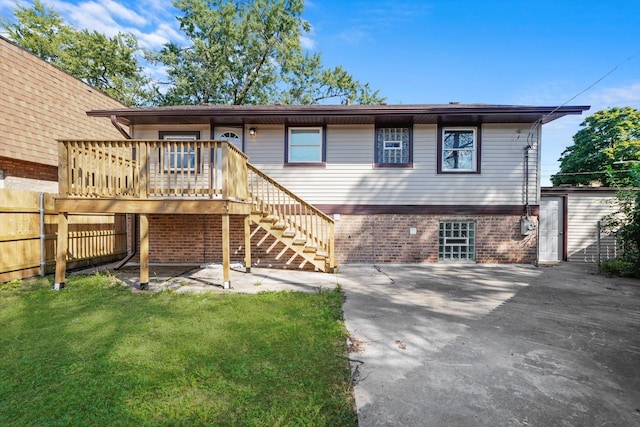 back of house featuring a yard, a deck, and a patio area