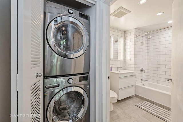 washroom featuring stacked washer / dryer