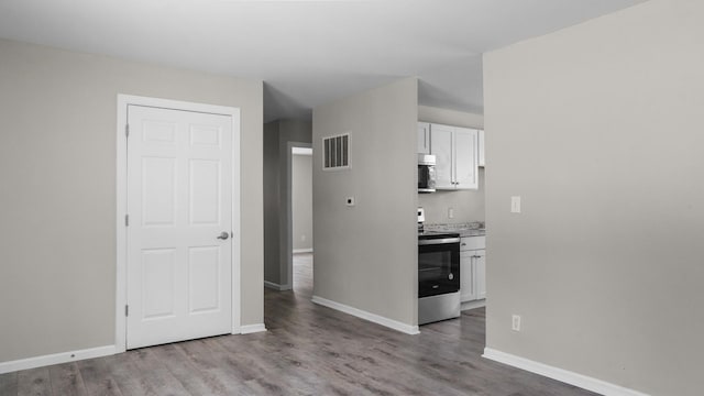 kitchen featuring white cabinets, stainless steel appliances, and light hardwood / wood-style floors