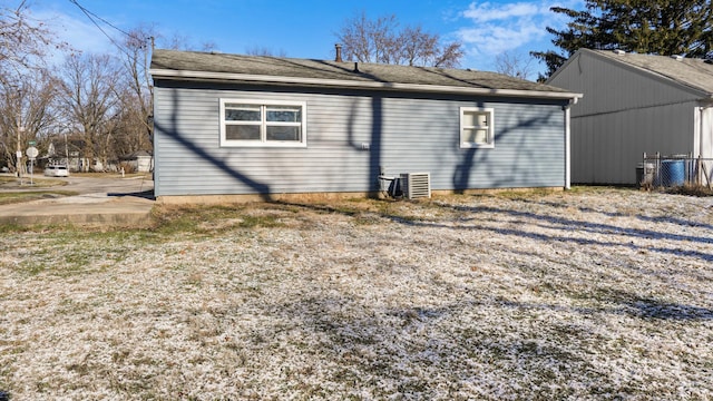 rear view of property with central AC