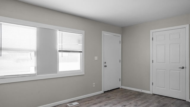 spare room with light hardwood / wood-style flooring