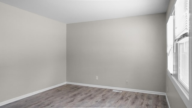 unfurnished room with light wood-type flooring