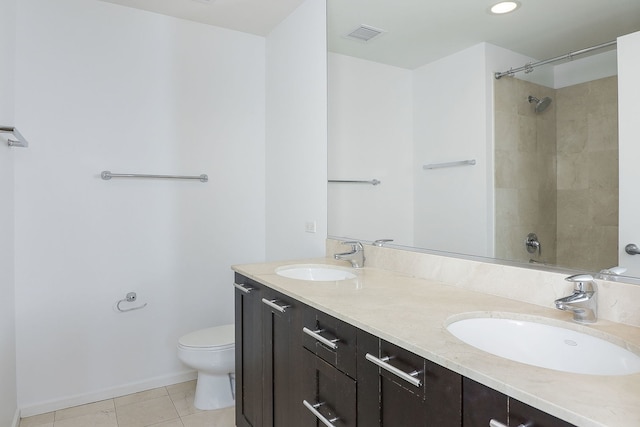 bathroom featuring tile patterned flooring, vanity, and toilet