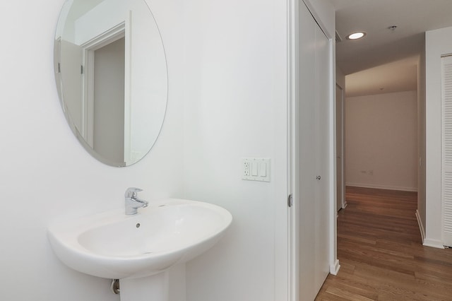 bathroom with hardwood / wood-style flooring and sink