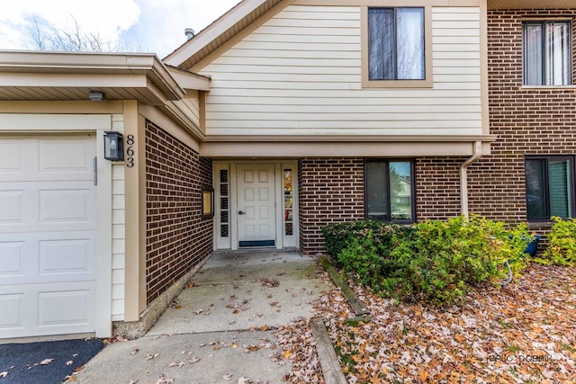 doorway to property with a garage