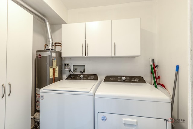 laundry area with cabinets, washing machine and dryer, and gas water heater