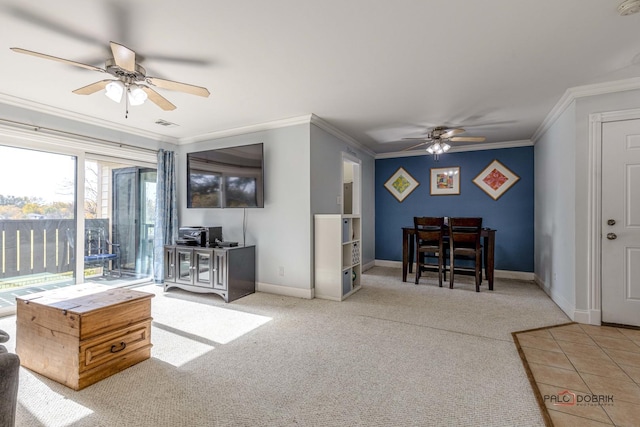 carpeted living room with ceiling fan and crown molding