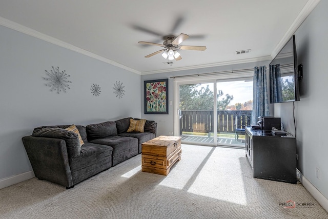 carpeted living room featuring ceiling fan and ornamental molding