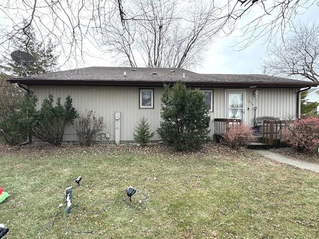 rear view of property featuring a yard