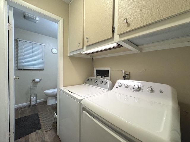 laundry area featuring dark hardwood / wood-style floors and washer and clothes dryer