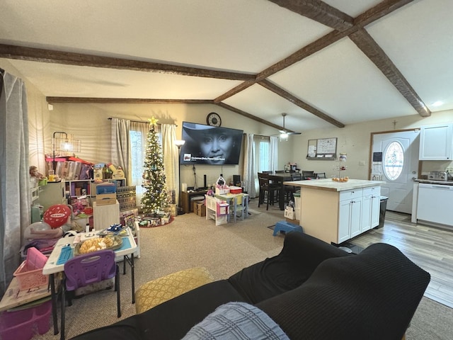 living room with ceiling fan, lofted ceiling with beams, light hardwood / wood-style floors, and a wealth of natural light