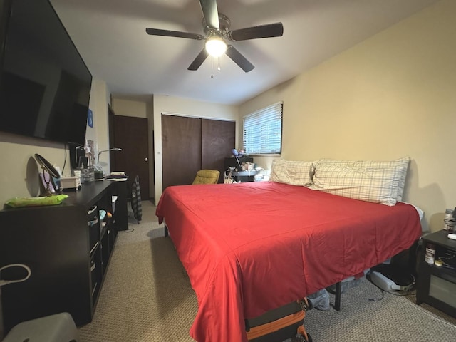 bedroom featuring ceiling fan, a closet, and light colored carpet