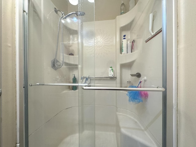 bathroom with a shower with shower door