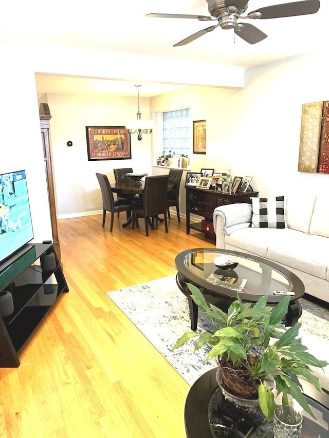 living room featuring hardwood / wood-style floors and ceiling fan