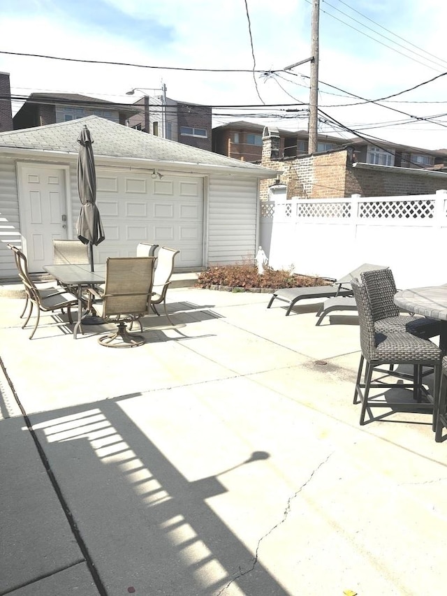 view of patio featuring an outbuilding and a garage