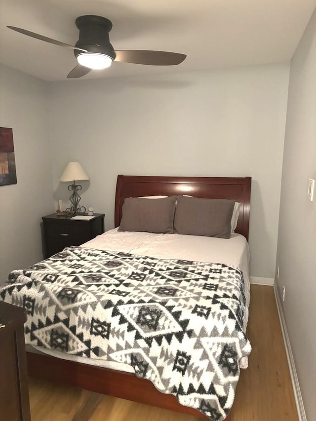 bedroom featuring ceiling fan and dark hardwood / wood-style floors