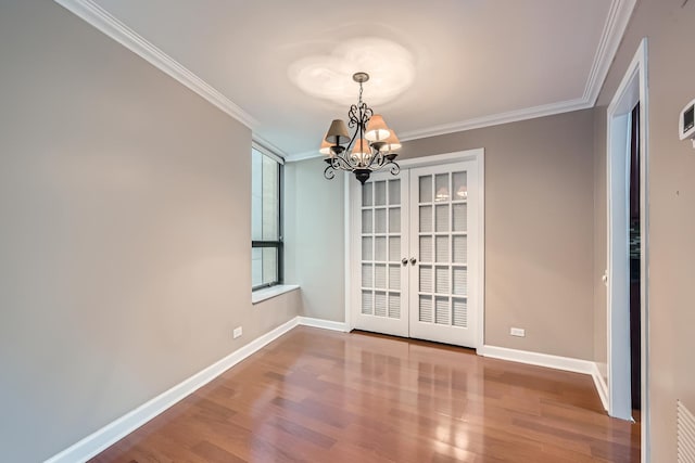 unfurnished dining area with hardwood / wood-style flooring, a notable chandelier, and ornamental molding