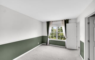 spare room featuring light colored carpet