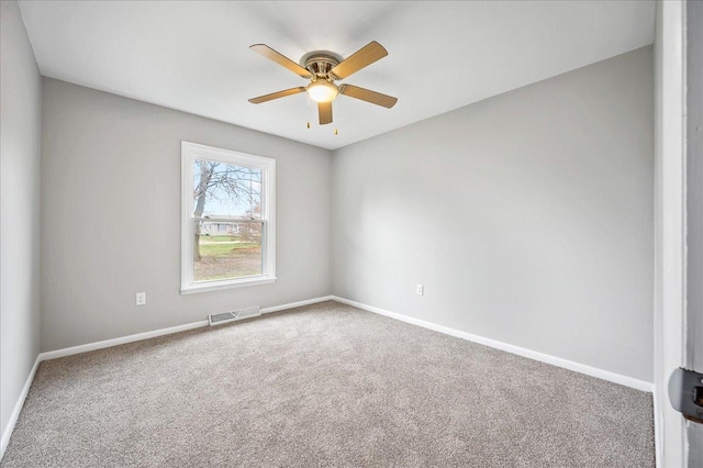 carpeted spare room with ceiling fan