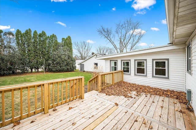 wooden deck featuring a lawn