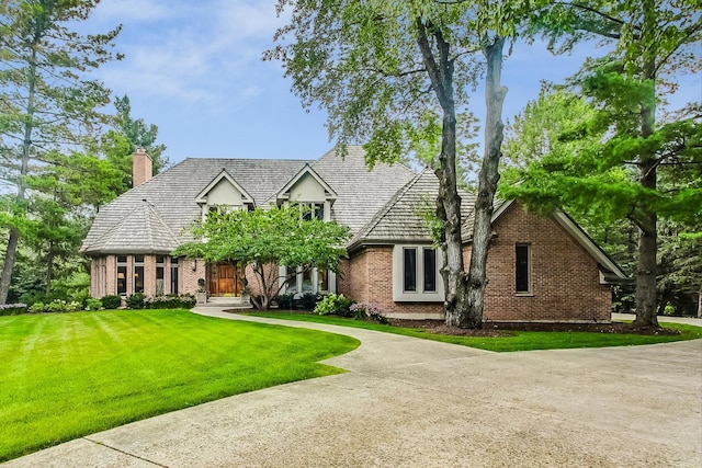 tudor-style house with a front lawn