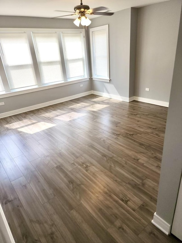 empty room featuring dark hardwood / wood-style flooring and ceiling fan